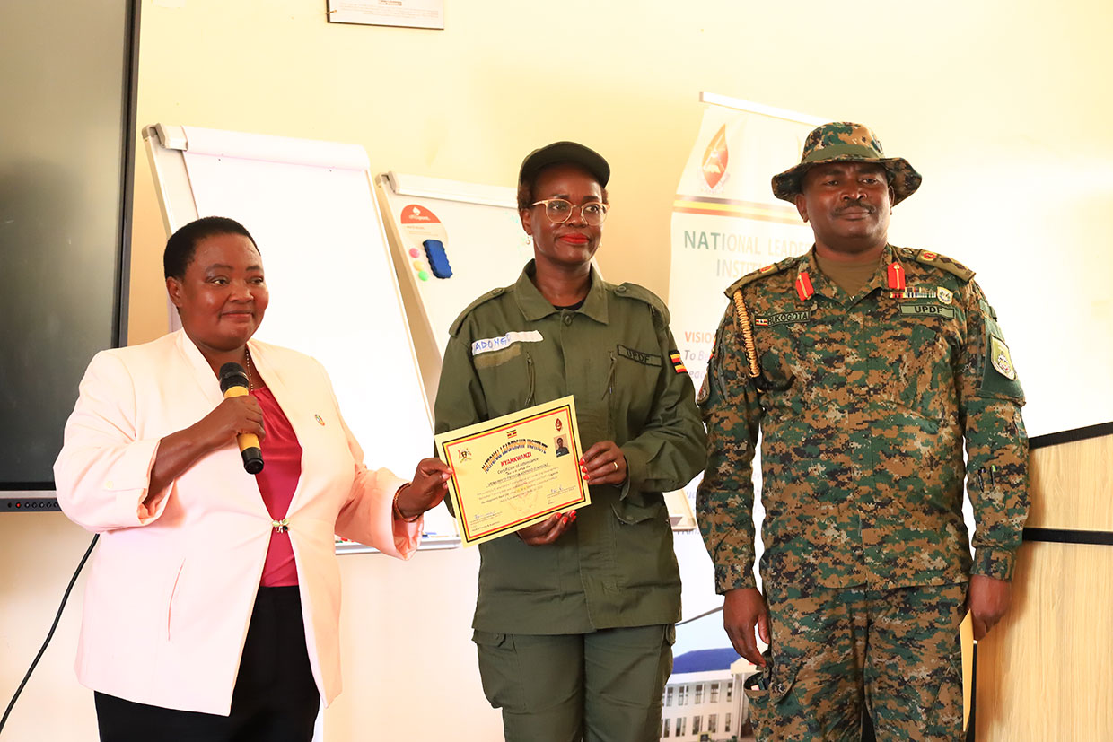 PM Rt Hon Robinah Nabbanja (L) hands a Certificate to UDB Managing Director, Dr. Patricia Ojangole (C). Right is Col. Okei Rukogota